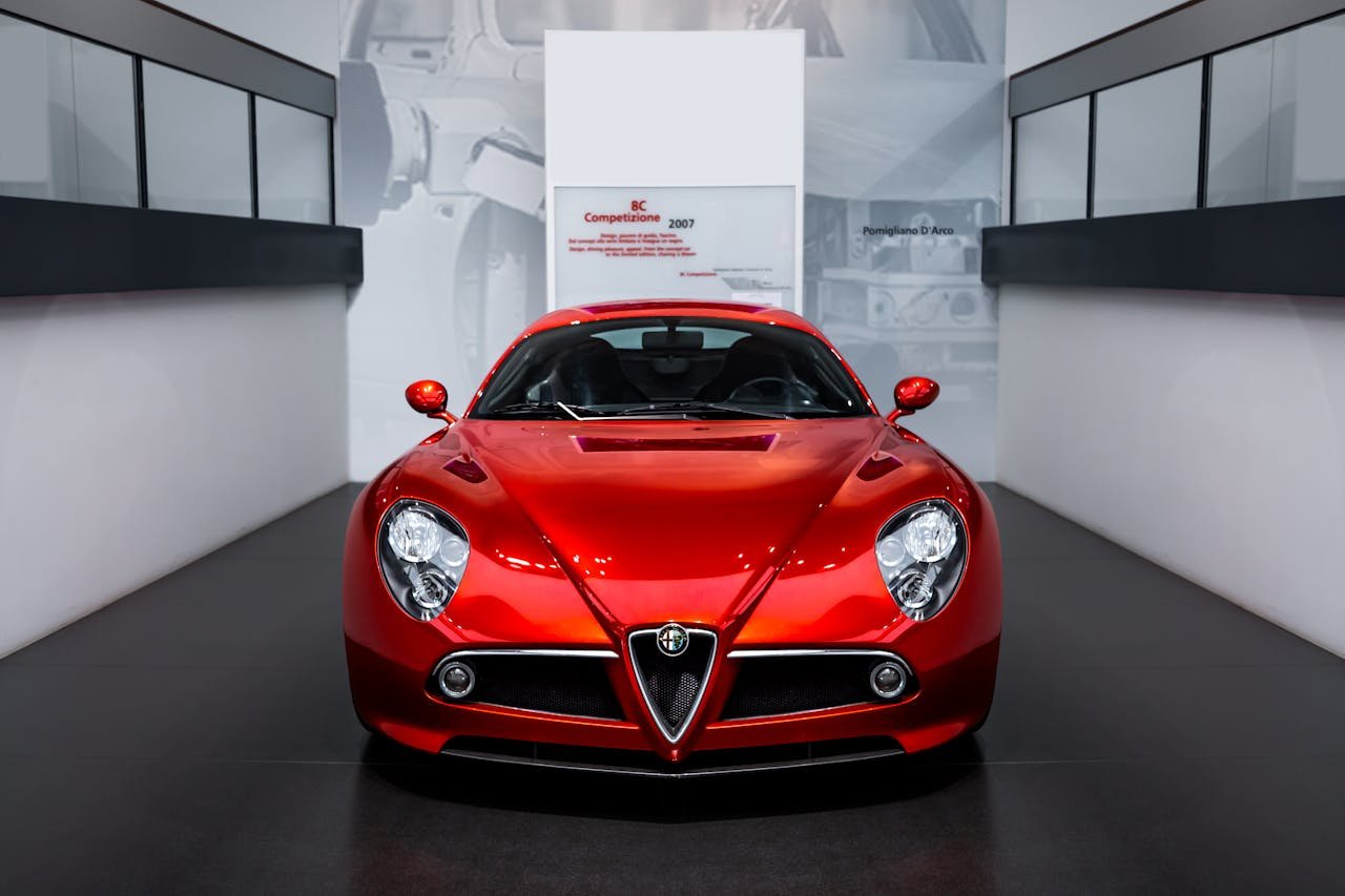 Elegant Alfa Romeo 8C Competizione displayed in a sleek, modern indoor showroom.